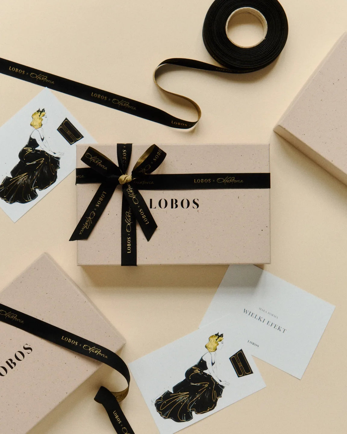 LOBOS boxes with a LOBOS × Olfaktoria ribbon and cards illustrated by Anna Halarewicz
